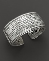 A lovely silver cuff by John Hardy, with woven silver band filigree etching along the interior.