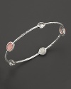 Alternating stones in blush, clear quartz and mother-of-pearl bring a sweet flush to this sterling silver bangle.