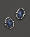 A fluted edge in sterling silver frames sparkling blue sapphires. From Lagos.