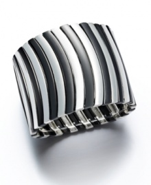 Bold design for the stylish woman. Alfani's wavy stretch cuff bracelet slips over the wrist and adds instant dimension to your wardrobe. Crafted in silver tone and hematite tone mixed metal. Approximate length: 7-1/2 inches. Approximate diameter: 2-1/2 inches.