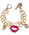 Style is what passes between these lips. This Betsey Johnson charm bracelet is crafted from antique gold-tone mixed metal with glass pearl and beaded accents. Item comes packaged in a signature Betsey Johnson Gift Box. Approximate length: 7-1/2 inches.