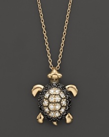 Black and white diamonds set in a 14K. yellow gold turtle pendant.