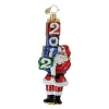 Santa carries a toppling tower of gifts, labeled with the year to celebrate the season.