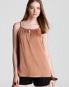 Marrying feminine detail with a warm copper tone, this Vince silk cami tops of casual separates with elegant ease.