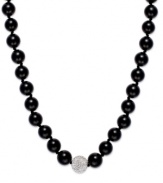 A traditional style with sleek, modern appeal. This smooth strand showcases shiny onyx beads (10 mm) and a sparkling crystal ball at center (12 mm). Clasp crafted in sterling silver. Approximate length: 18 inches.