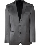 Elegant jacket in fine, grey cotton and synthetic fiber blend - Fabric has a slight, sleek sheen - Single breasted blazer style with two-button closure - Small collar and slim lapels - Two front flap pockets, single chest pocket - Side vents at rear - Modern silhouette is straight and slim - A polished, slick staple in any wardrobe - Dress up with suit trousers and a button down, or pair with jeans and a t-shirt for a more casual look