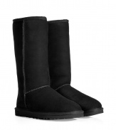 A tried-and-true cold weather staple, these tall classic shearling boots from UGG Australia boast comfort and utilitarian chic - Round toe, rugged rubber sole, exposed seams, cozy shearling lining, back logo detail - Tall shaft height - Pair with skinny jeans, an oversized cashmere sweater, and a down jacket or wool cape