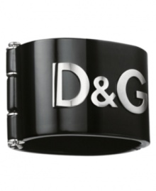 Give your wrist a bold kick with this stylish cuff bracelet from D&G Dolce & Gabbana. With an extra wide 2-1/2 inch width and an industrial inspired clasp closure, it features a silvertone stainless steel raised logo on black resin.