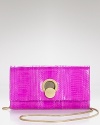 DIANE von FURSTENBERG's retro swag is right for night with this genuine watersnake clutch. Tuck it under your arm to make every outfit coolly complete.