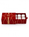 Captures the aroma of a sparkling holiday season. A total of six votives per box fragranced with inviting notes of pomegranate, mandarin orange, pine, cloves and cinnamon. Housed in elegant miniature glass vessels and presented in a red velvet box. Created by Laura Slatkin. Approximately 2 to 3 hours of burn time per votive.