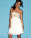 Flirty and sweet, this sequined party dress from Trixxi is made all the more cute with a tulle skirt and empire waist!