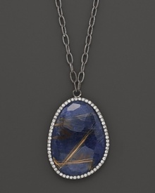 Diamonds circle faceted blue sodalite set in blackened sterling silver. By Di Massima.