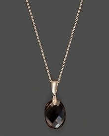 Diamonds accent a faceted smoky quartz, set in 14K rose gold.