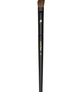 This angled, natural-bristled brush is the ideal partner to all eye shadows. Its slightly rounded edges perfectly apply shadow to the crease and corners of the eye. Brush hairs are slightly more narrow for controlled application. How to use: Dip the angled side of the brush into the shadow and tap off excess. For crease contouring press the angled side horizontally into the crease with the longer end toward the outside of the eye. For a bolder effect press vertically into the crease with the longer end downward. For corner contouring sweep the angled side downward from the outermost area of the crease, toward the lashes, finishing above the iris.