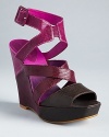 Lizard-embossed uppers give strappy platform wedge sandals an extra does of style; from Juicy Couture.