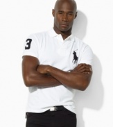 Designed with a relaxed cut through the body and a longer hem, an iconic polo shirt is rendered in breathable cotton mesh with athletic details for sporty style.