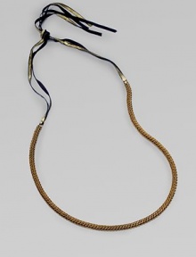 A fine herringbone chain with a gilded grosgrain ribbon tie.Brass Grosgrain ribbon Adjustable ties About 25½ long Imported