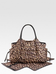 Puffy, channel-quilted nylon in a chic leopard print with patent leather straps and trim.Top zipper Two outside bottle pockets Inside stroller straps Removable changing pad with diaper pockets Two inner bottle pockets Inner back zip pocket and side pockets 18W X 11¾H X 5D Imported