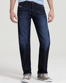 Suave straight leg jeans by Diesel in a robust dark wash, offset by bright orange stitching.