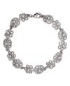 Freshen your look with this sparkling, floral motif. Monet's elegant flex bracelet shines with the addition of white glass pearls and crystal embellishments. Crafted in silver tone mixed metal. Approximate length: 7-1/2 inches.