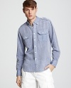 Shoulder epaulets and double button pockets add a touch of military chic to this handsome chambray sport shirt.