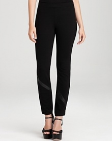 Leather trim outfits these sleek DKNY leggings with pure urban edge. Style with strappy sandals and rock n' roll to the top of the fashion set.