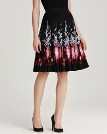 Bold florals blossom alongside the fluttering hemline of this pleated DKNY skirt. Pair with black pumps and a fitted blouse for classic feminine appeal.