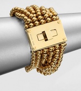 From the Modern Classics Collection. Bold and beautiful strands of polished beads with a glowing golden finish are connected to a striking turn-lock clasp in this sophisticated design.GoldtoneLength, about 7Width, about 1.75Turn-lock claspImported