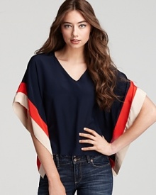 An airy, voluminous silhouette lends graceful movement to this Akiko top, boasting contrasting stripes at the extra-wide sleeves for a bold punch of color.