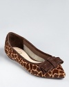 In giraffe printed haircalf, these Delman flats feel ladylike in a pointed silhouette, embellished with a soft suede bow.