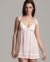 A whimsical babydoll with bow appliqués at straps and beaded trim along the hem.