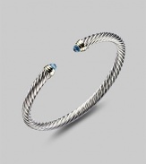 From the Color Classics Collection. A graceful sterling silver cable, capped with faceted blue topaz domes and accents of 14k gold. Blue topaz Sterling silver and 14k yellow gold Cable, 5mm Diameter, about 2¼ Imported