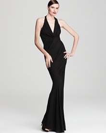 Make a stunning statement at your next event in this sweeping Donna Karan New York gown, elegantly shaped by a twist at the front with a daring deep v neckline to showcase an alluring décolletage.