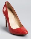 The softest stripes form a faint pattern on these glossy Calvin Klein pumps, crafted in a vibrant coral hue.