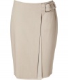 Your workweek look just got more sophisticated with this luxe denim wrap skirt from Akris - Front slit with layering detail, faux-wrap style with buckle at waistband, concealed back zip closure - Pair with a tie-neck blouse, nude fishnets, a bold-shouldered blazer, and peep-toe platforms