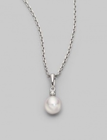 Simple and lovely, a white, round cultured Akoya pearl has a sparkling diamond accent, plus a chain and setting of 18k gold. 7mm white round cultured pearl Quality: A+ Diamond, 0.05 tcw 18k white gold Length, about 18 Spring ring clasp Imported