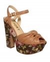 Get carried away with sweetness. Floral fabric wraps the platform and heel of the charming, leather Ray sandals by Report.