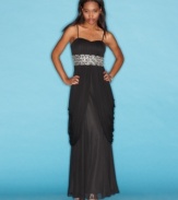 Party in grand style with this gown from B Darlin that's gorgeously jeweled and draped to perfection!