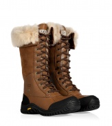 Brave the elements in style this season with UGG Australias ultra warm Adirondack tall lace-up boots, finished with waterproof full grain leather and sheepskin lining for an ultra luxe edge - Rounded toe, leather and suede upper, canvas lace-up front, thick rubber lug sole - Hits below the knee - Pair with sporty outerwear and fun, bright knitwear