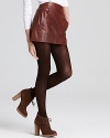 A luxe Vince leather skirt lends downtown style to fall. Flaunting cool pleats at the front, this supple style is complete with tonal tights and lace-up, textured booties.