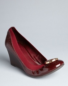 Your favorite Tory Burch logo flats stand tall placed on platform wedges. Give your look a lift.