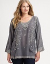 Whimsically designed, an exquisite tunic featuring pretty embroidery, eyelet details and a fit you will love.Round neckLong sleevesEmbroidered detailsFront pocketsAbout 30 from shoulder to hemRayonMachine washImported