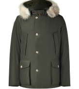 Sporty down parka in olive, coated cotton - A classic by the status brand Woolrich, this parka guarantees to keep you warm up to minus 35 degrees  - With genuine goose down - and a snow-resistant coating - Cozy hood with fur trim - Zipper close and additional button placket - Side pockets and flap patch pockets - Sleeves with windproof cuffs - Awesome below the hip length - A dream piece forever, once you wear this parka, youll never put on any other for winter - Suitable for both business attire as well as all casual outfits