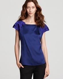 Ablaze with a vibrant jewel tone, this Elie Tahari blouse ignites your workweek repertoire. Slip the style under a blazer for the 9-to-5, then garnish with gold accents for an elegant evening alternative.