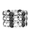 Versatility and shimmer at its best. Monet's trendy three-row style features discs crafted from silver and hematite tone mixed metal. Bracelet stretches to fit wrist. Approximate diameter: 2-1/4 inches.