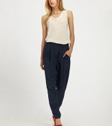 A relaxed pair of silk trousers, tapered at the cuffs, make the ultimate work or weekend go-to.Elasticized waistFront pleatsRelaxed through hip and thighTapered cuffsBack slash pocket with button closurePull-on styleRise, about 32Inseam, about 28SilkDry cleanImported