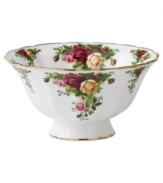 Garnished with the popular Old Country Roses dinnerware pattern, this footed Royal Albert bowl brings the bounty of the English countryside to your table in fine bone china with gold, scalloped edges.