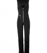 Make a chic statement on the slopes in Jet Sets ultra modern stretch ski overalls, finished with a flattering cut guaranteed to show off your sporty side in style - Snapped scooped neckline, sleeveless, exposed front zip, zippered pockets, seamed knees, zippered ankles, inside elasticized cuff lining with silicon band for hold - Form fitting through the thigh, straight leg, slightly flared ankle - Wear with form-fitting turtlenecks and glamorous oversized sunglasses