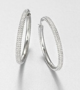 From the Brilliance Collection. The design is simple but the look is shimmering in these slender hoops set with rows of dazzling rhinestones.GlassSilvertoneDiameter, about 1.25PiercedImported