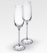 A pair of delicate, elegant and very festive flutes are made for special occasions in clear crystal with faceted crystal stems that adds an element of romance to any evening. Each, 10H X 2¾ diam. Hand wash Made in Austria